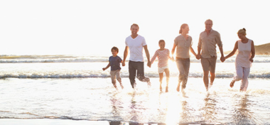 family holding hands in the beach