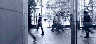 People walking through office lobby