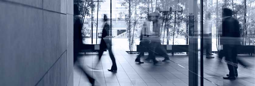 People walking through office lobby