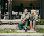 old couple sitting outside with tea