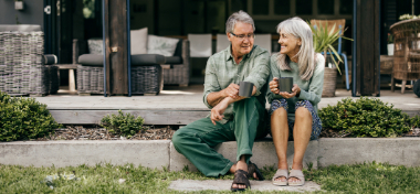 old couple sitting outside with tea