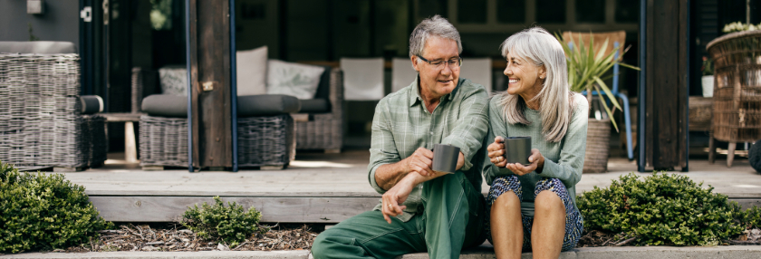 old couple sitting outside with tea