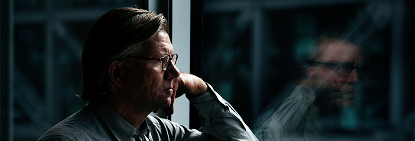 man looking out the window